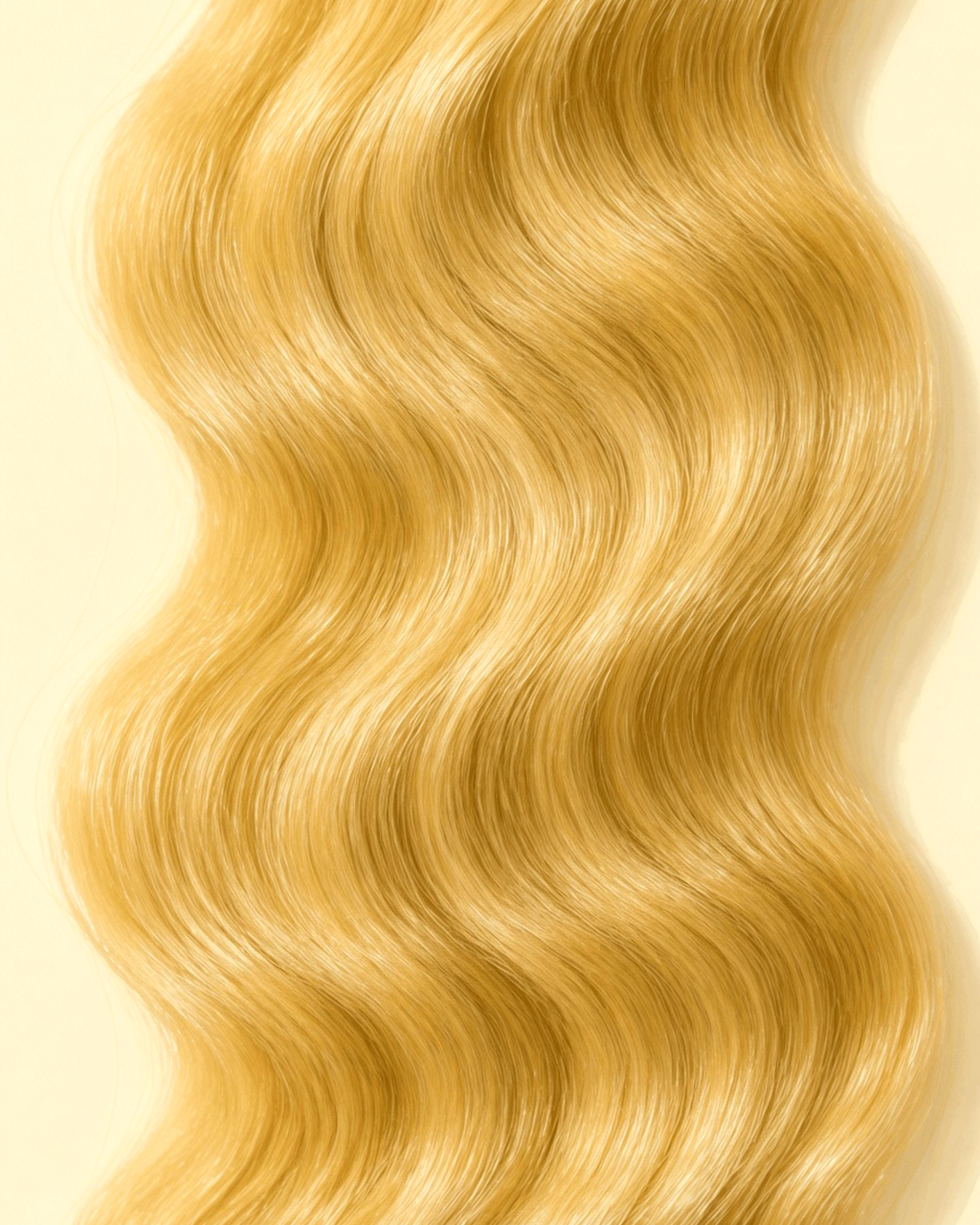 Close-up of #613 blonde body wave curl pattern and strand texture